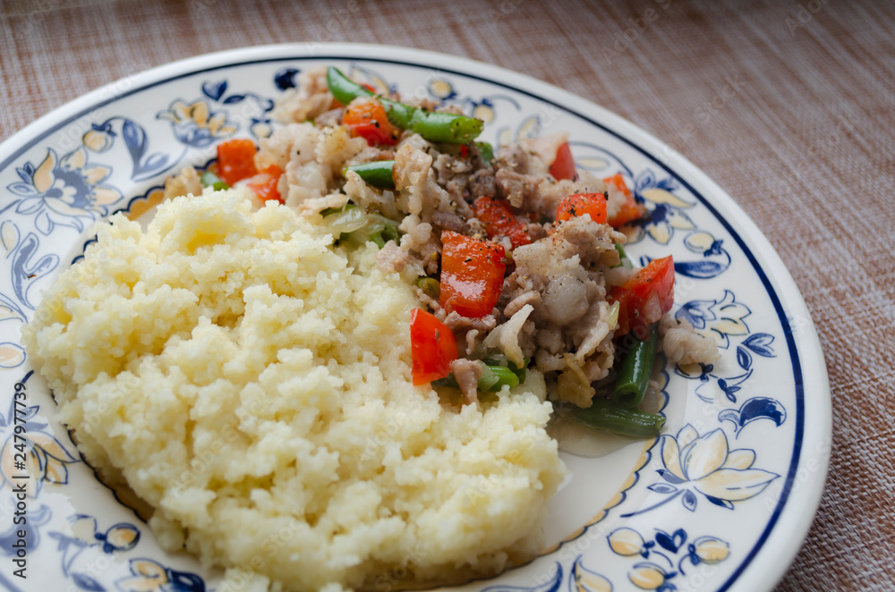 couscous, meat, bell pepper and green beans on a plate couscous, meat, bell pepper and green beans on a plate