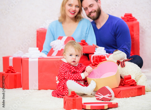 Love. father, mother and doughter child. Shopping online. Boxing day. Love and trust in family. Bearded man and woman with little girl. Happy family with present box. Valentines day. Red boxes