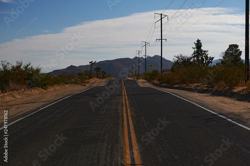 Long winding road through mountain and desert landscape in California