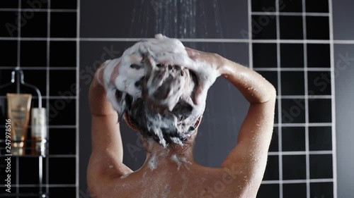 Woman washes her hair with shampoo in the shower with, hair care, ceratin mask, rinse shampoo and balm, strong hair, washing hair
