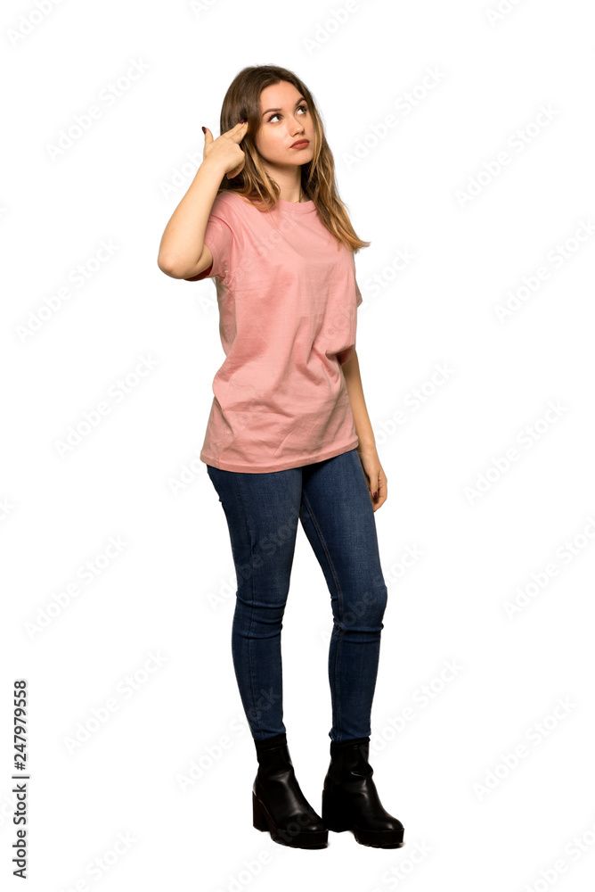 A full-length shot of a Teenager girl with pink sweater with problems making suicide gesture on isolated white background A full-length shot of a Teenager girl with pink sweater with problems making suicide gesture on isolated white background
