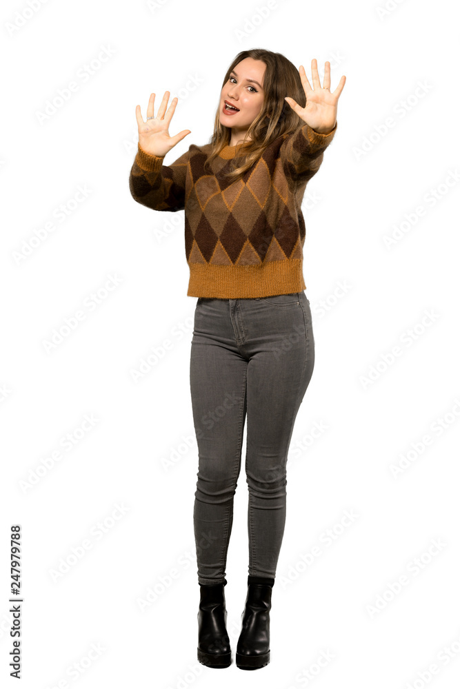 A full-length shot of a Teenager girl with brown sweater counting ten with fingers over isolated white background A full-length shot of a Teenager girl with brown sweater counting ten with fingers over isolated white background
