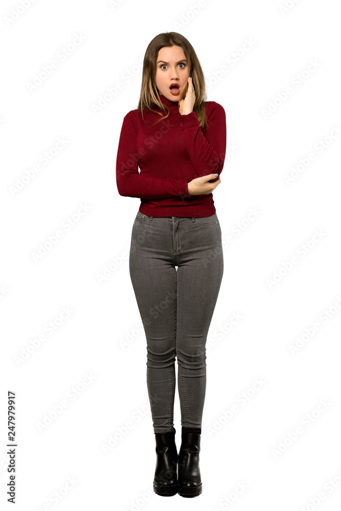 A full-length shot of a Teenager girl with turtleneck surprised and shocked while looking right over isolated white background A full-length shot of a Teenager girl with turtleneck surprised and shocked while looking right over isolated white background