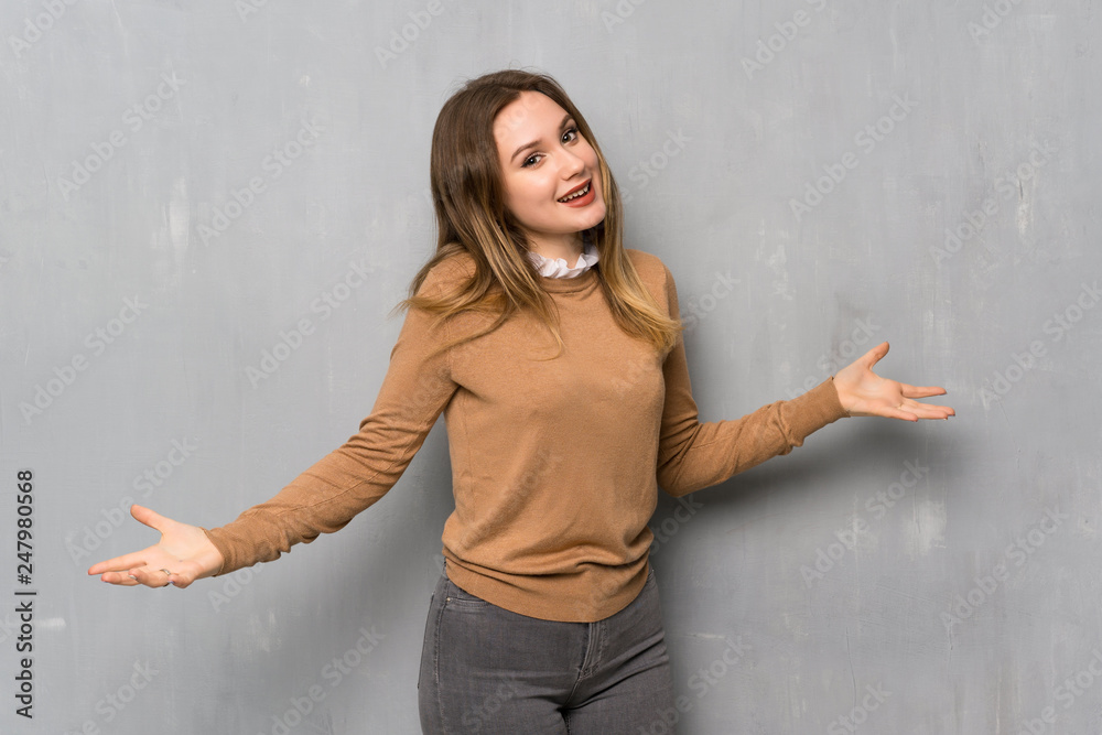Teenager girl over textured wall proud and self-satisfied Teenager girl over textured wall proud and self-satisfied
