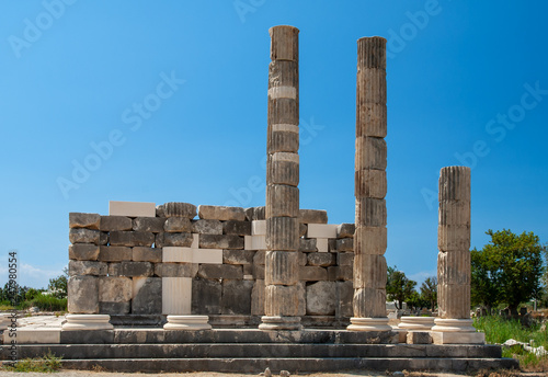 Antique ancient Temple Leto, the goddess of Greek mythology on the ruins of Letoon. Beautiful landscape on the background of clean blue sky Turkey.