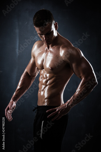 Athletic shirtless young male fitness model posing © Maksim Toome