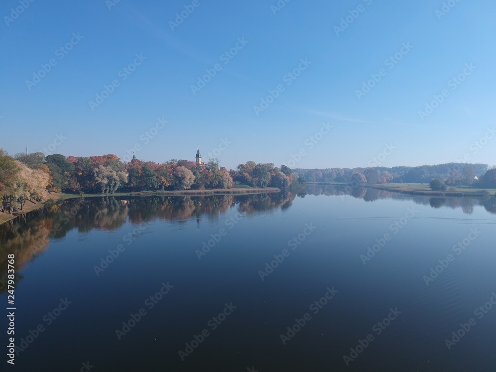 Nesvizh Castle from across the pond in autumn. Minsk Region, Belarus. Site of residential castle of the Radziwill family. 