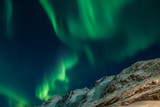 Amazing Aurora Borealis in North Norway (Kvaloya), mountains in the background