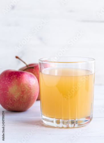 glass of juice and red apples