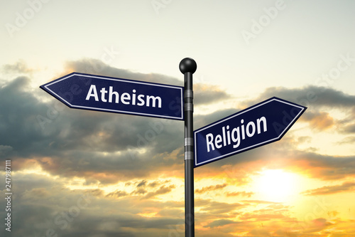 Фотография arrow road signs of words atheism and religion on the sunset sky