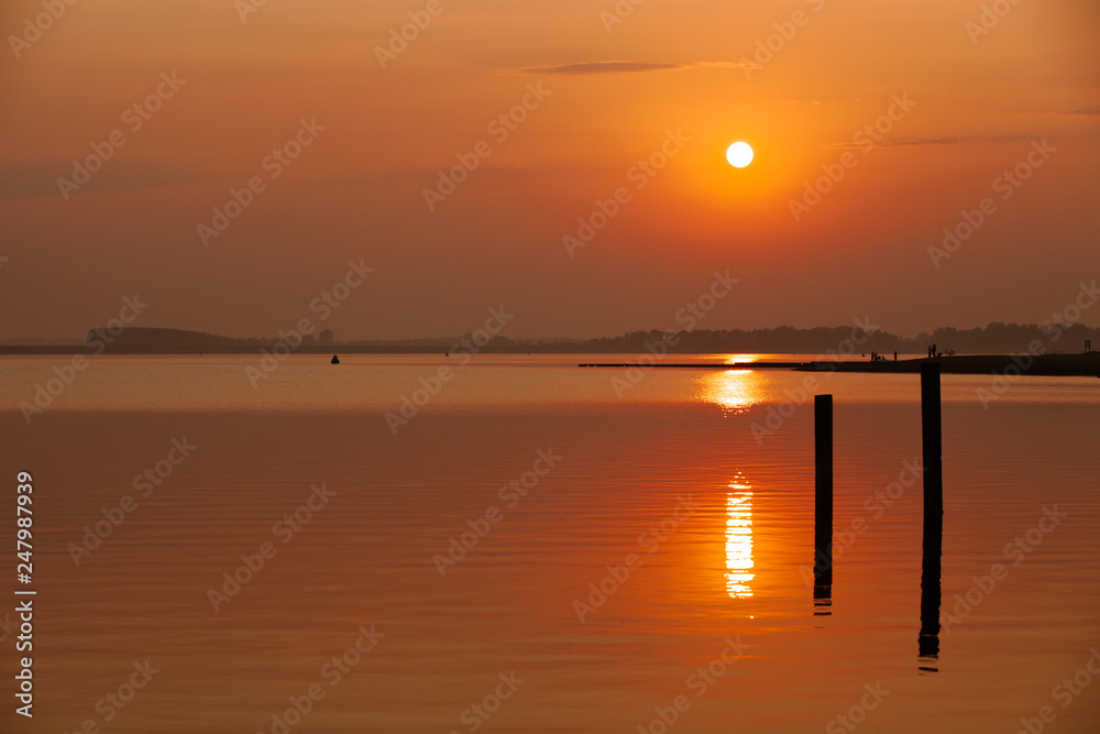 majestic sunset with warm water reflections at the Veerse sea in the Netherlands