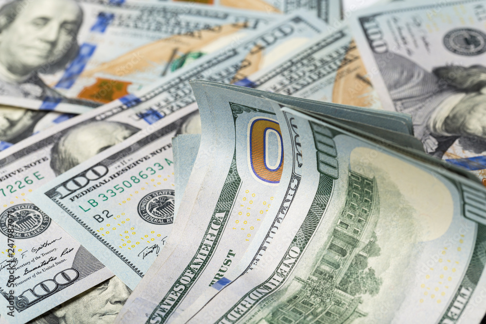 Fototapeta premium American dollars. A stack of hundred dollar bills. Close up