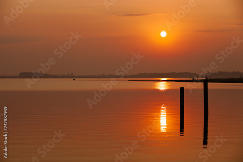 majestic sunset with warm water reflections at the Veerse sea in the Netherlands