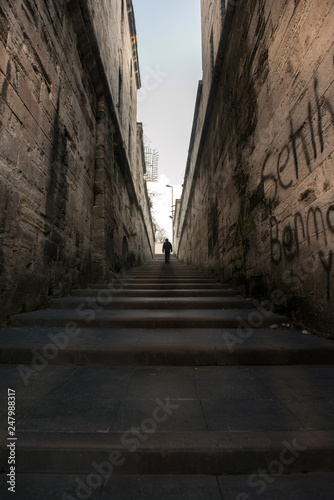 A man walking right up the long stairs