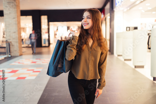 Woman in shopping. Happy woman with shopping bags enjoying in shopping. Consumerism, shopping, lifestyle concept