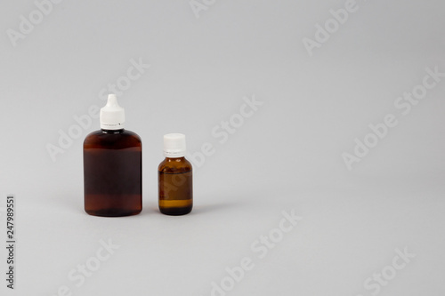 two brown glass bottles on gray background