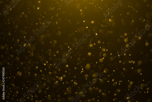 Golden bokeh background on light in the dark night