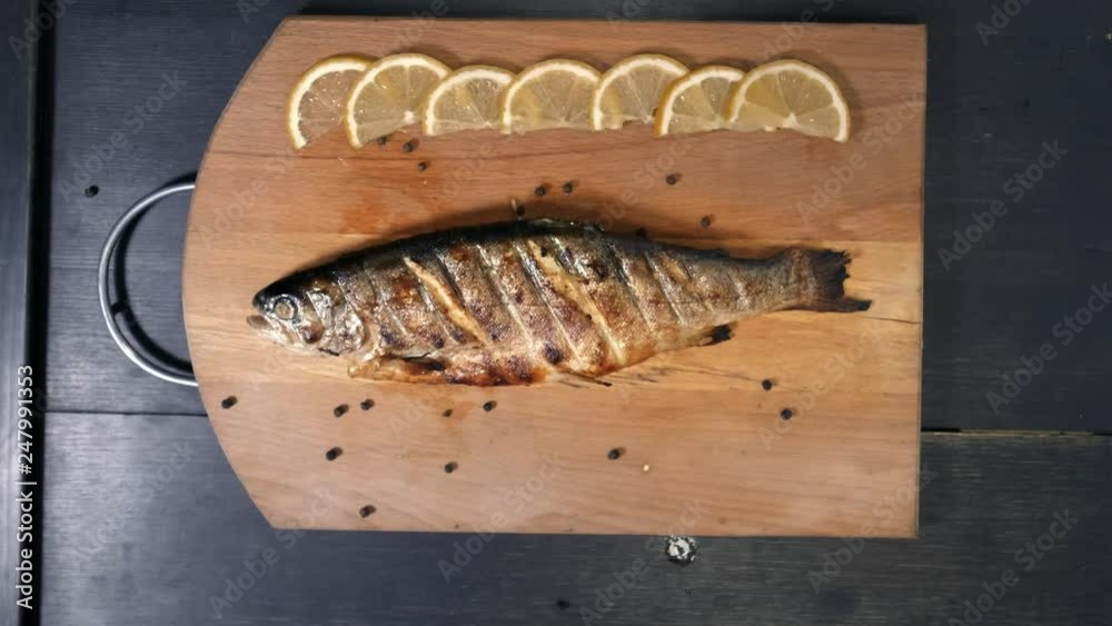 Chief cook decorating dish in restaurant Fish dish on plate. Chief cook decorating dish in restaurant Fish dish on plate.