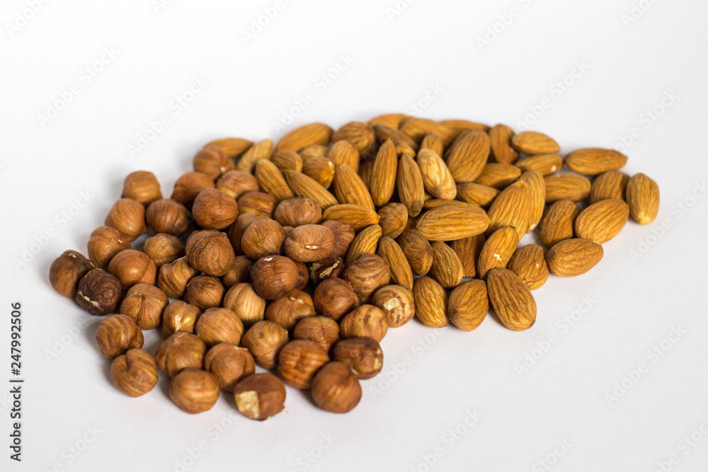 handful of nuts on a white background, almonds and hazelnuts handful of nuts on a white background, almonds and hazelnuts