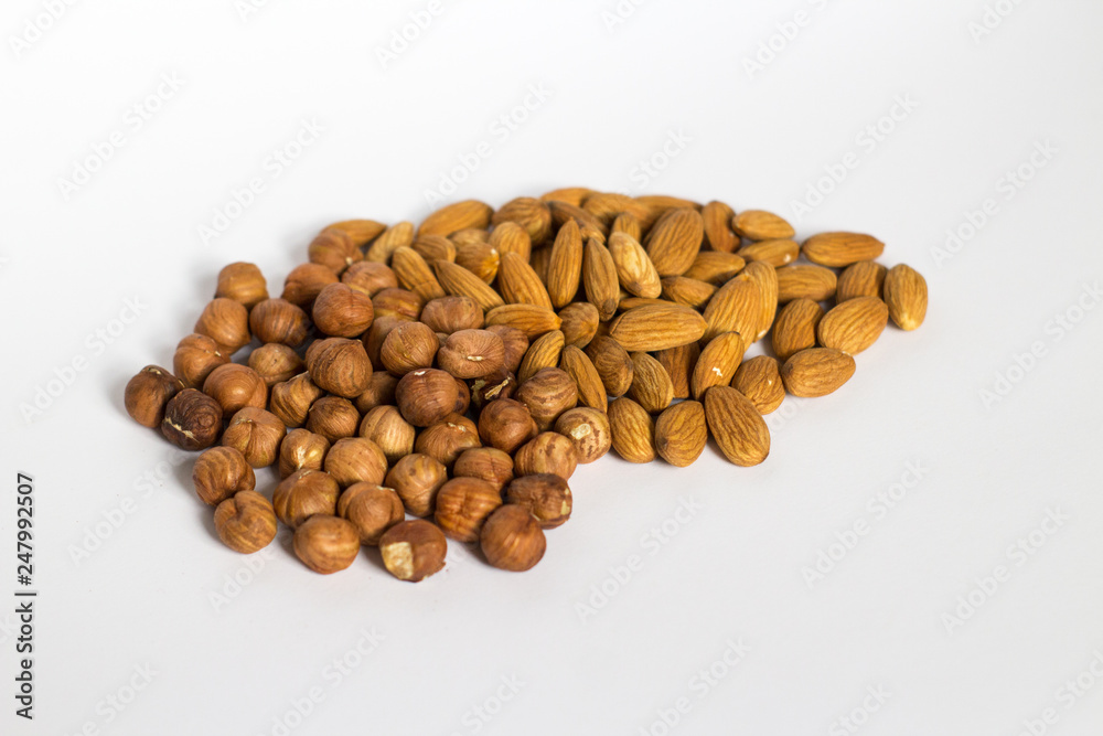 handful of nuts on a white background, almonds and hazelnuts handful of nuts on a white background, almonds and hazelnuts
