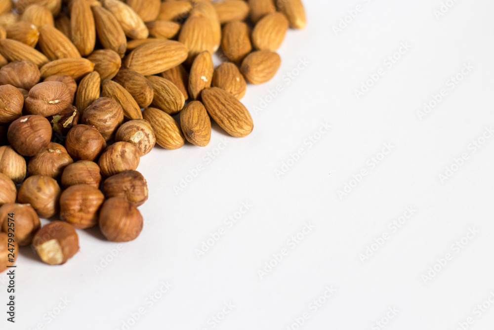 handful of nuts on a white background, almonds and hazelnuts handful of nuts on a white background, almonds and hazelnuts