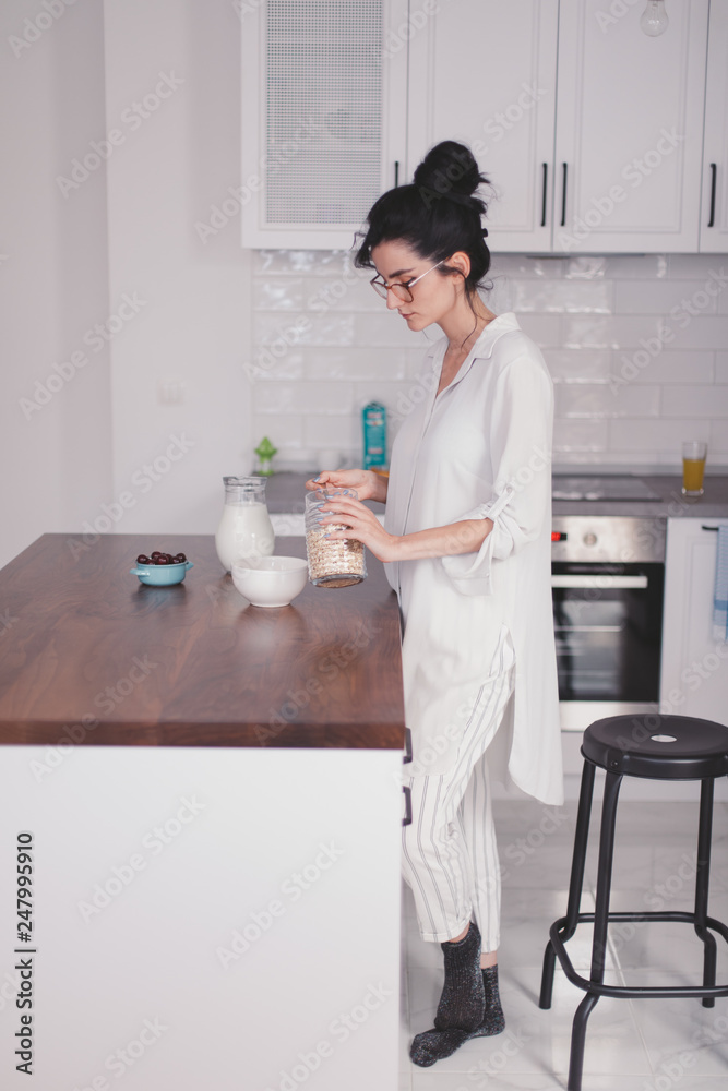 Beautiful young woman making breakfast in the kitchen Beautiful young woman making breakfast in the kitchen