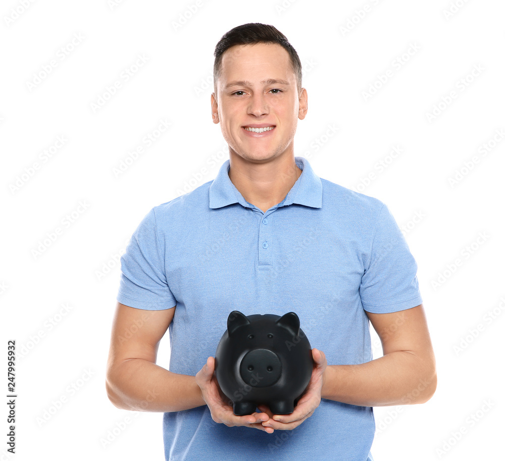 Young man with piggy bank on white background Young man with piggy bank on white background