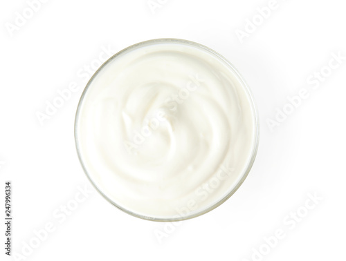 Glass bowl with creamy yogurt on white background, top view