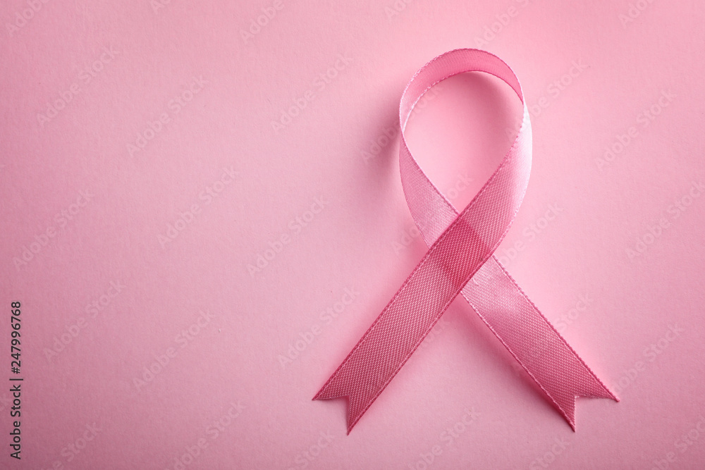 Pink ribbon on color background, top view with space for text. Breast cancer awareness concept Pink ribbon on color background, top view with space for text. Breast cancer awareness concept