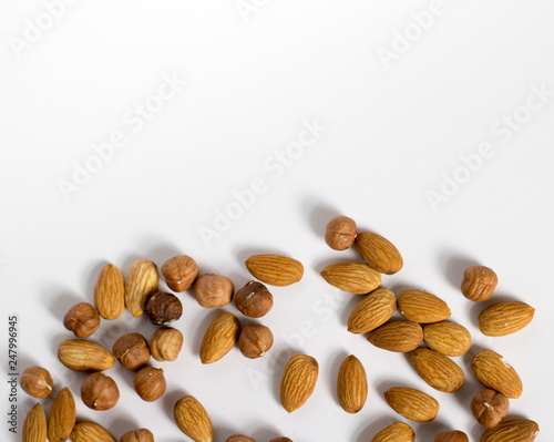  handful of nuts on a white background, almonds and hazelnuts