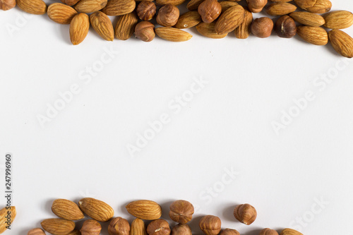  handful of nuts on a white background, almonds and hazelnuts