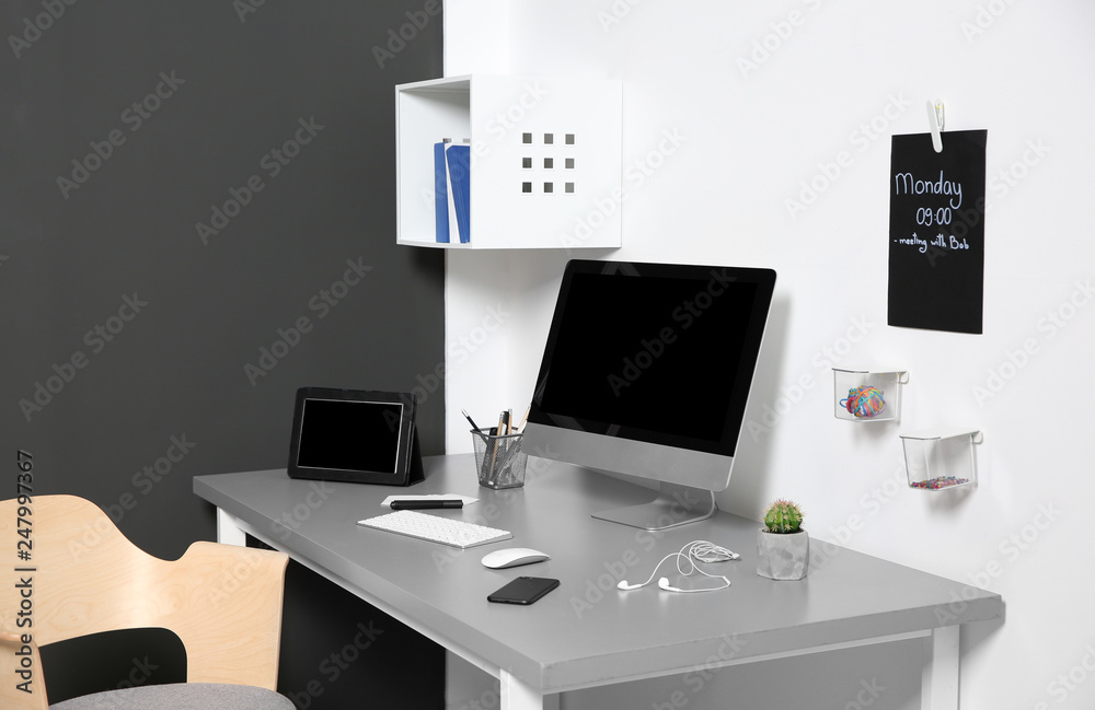 Modern interior of workplace with computer and accessories Modern interior of workplace with computer and accessories