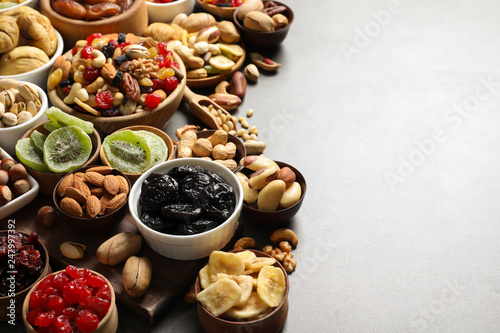 Composition of different dried fruits and nuts on color background. Space for text