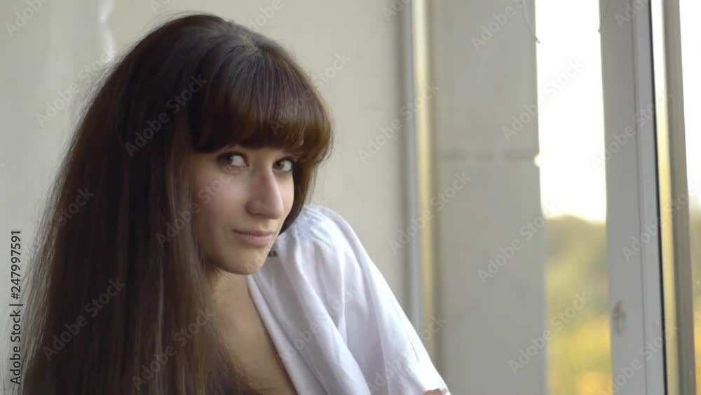 Portrait of Young Woman Sitting on the Window Portrait of Young Woman Sitting on the Window