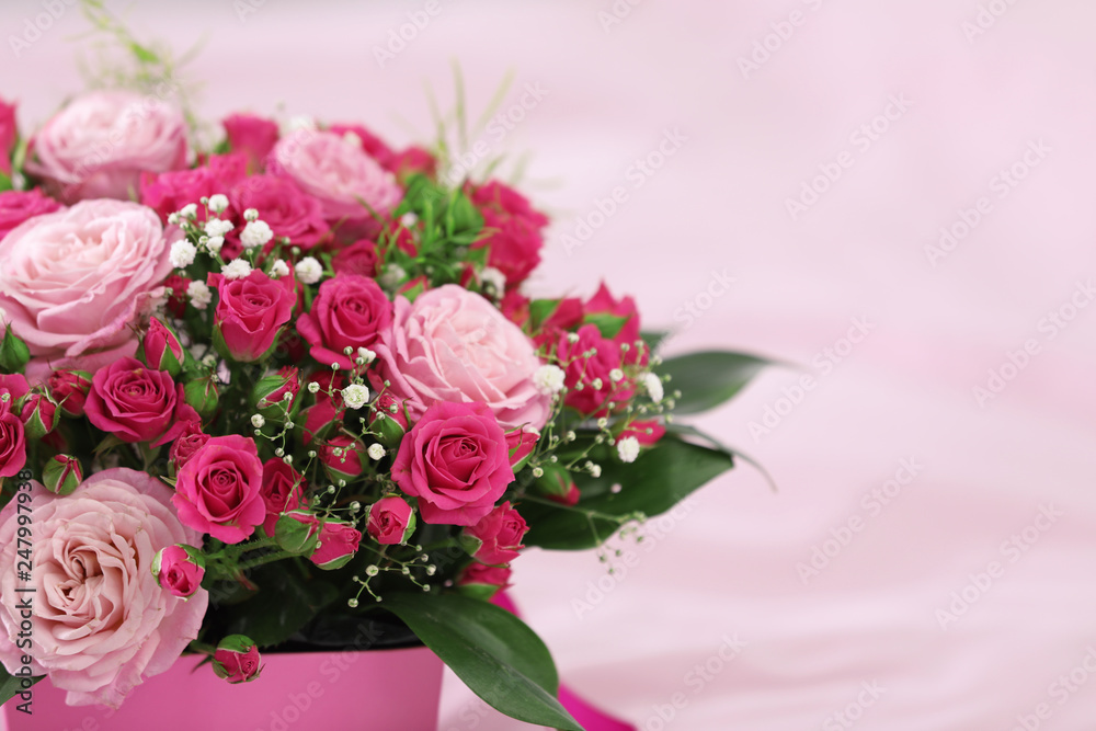 Beautiful bouquet of flowers in paper gift box on color background, closeup. Space for text Beautiful bouquet of flowers in paper gift box on color background, closeup. Space for text