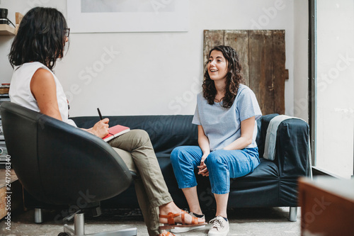 Psychotherapy session, woman talking to his psychologist in the studio photo