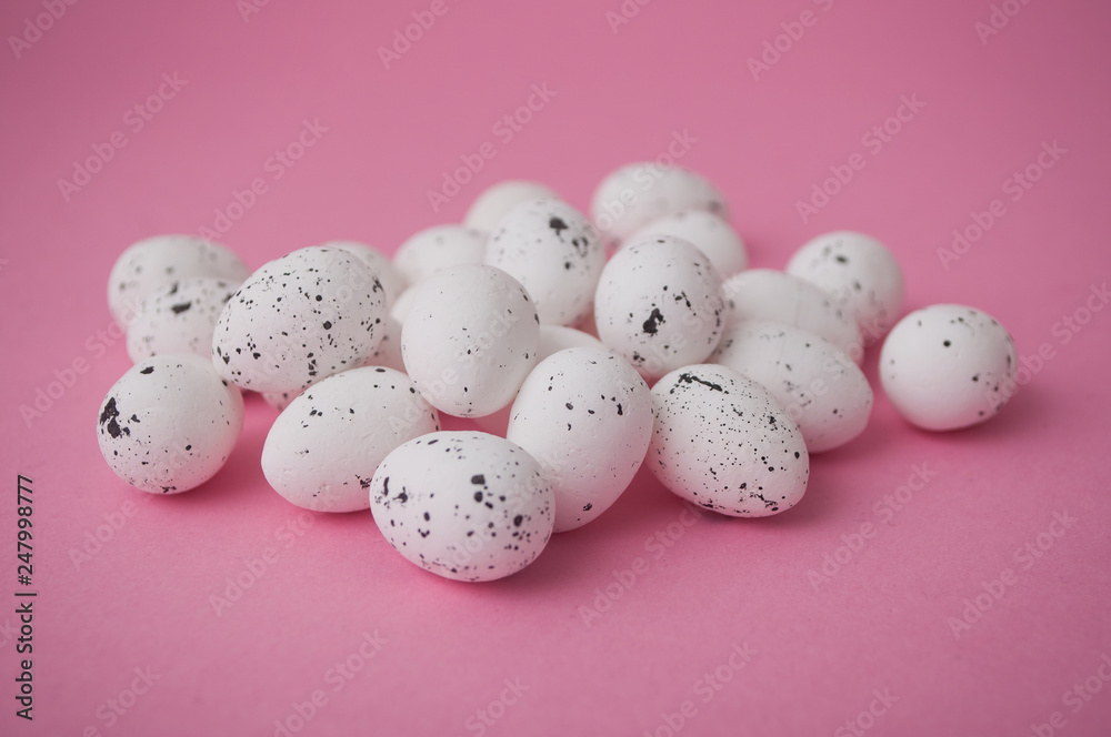 closeup of decorative easter eggs on pink background