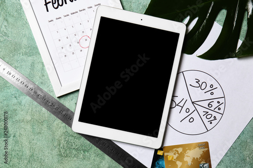 Tablet PC with diagram and calendar on color table. Concept of business planning