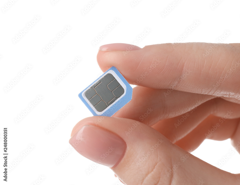 Female hand holding sim card on white background Female hand holding sim card on white background