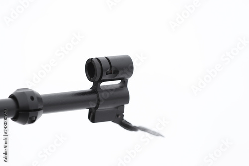 The muzzle of the rifle on a light background