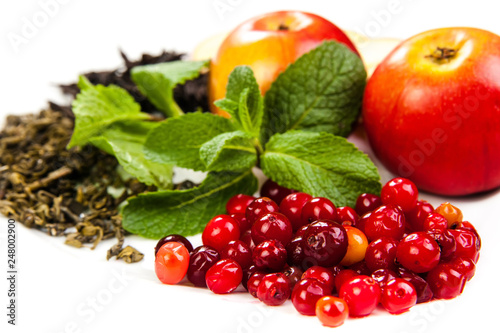 composition. black and green tea  mint  apples and berries on a white background isolated. concept of freshness natural nature health