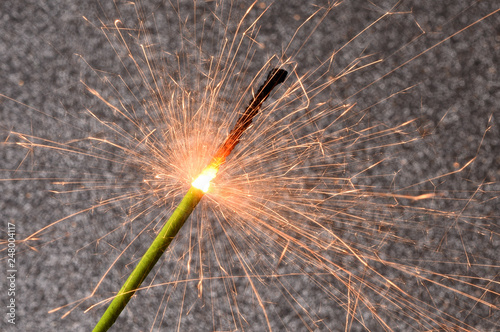 Burning sparkler isolated on black background