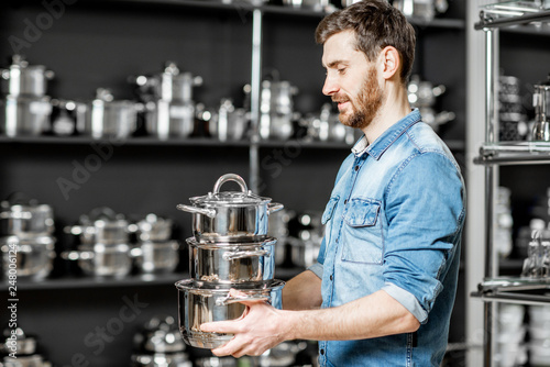 Man buying pans for cooking in the supermarket