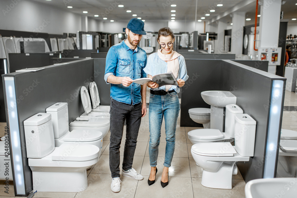Couple choosing toilet ceramics in the shop Couple choosing toilet ceramics in the shop
