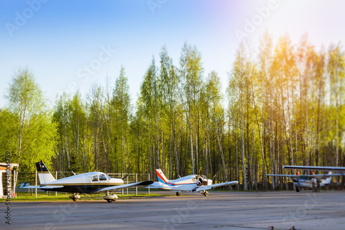 Light passenger planes parked before departure at private airport in Kronshtadt, St.Petersburg, Russia. Industrial and civil air transportation by aircraft. Professional flights on airplanes