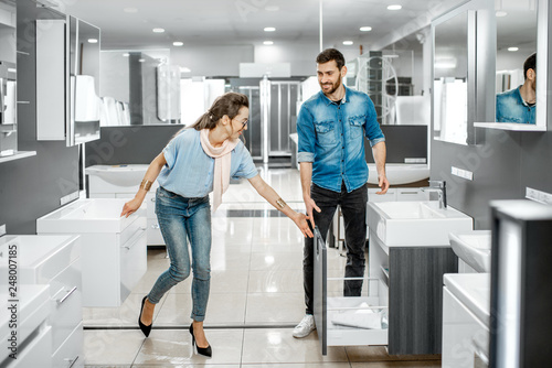 Couple chooosing new bathroom furniture in the shop