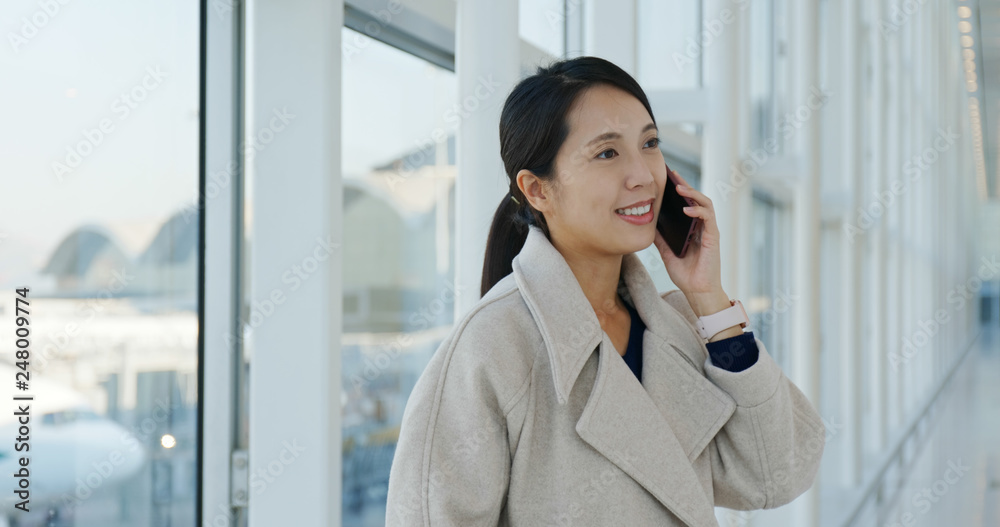 Woman talking on mobile phone in the airport