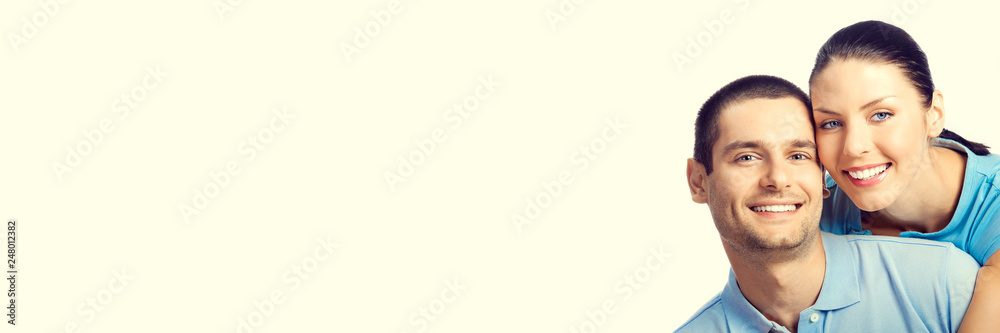 Young happy smiling couple, with copy space, over yellow background Young happy smiling couple, with copy space, over yellow background
