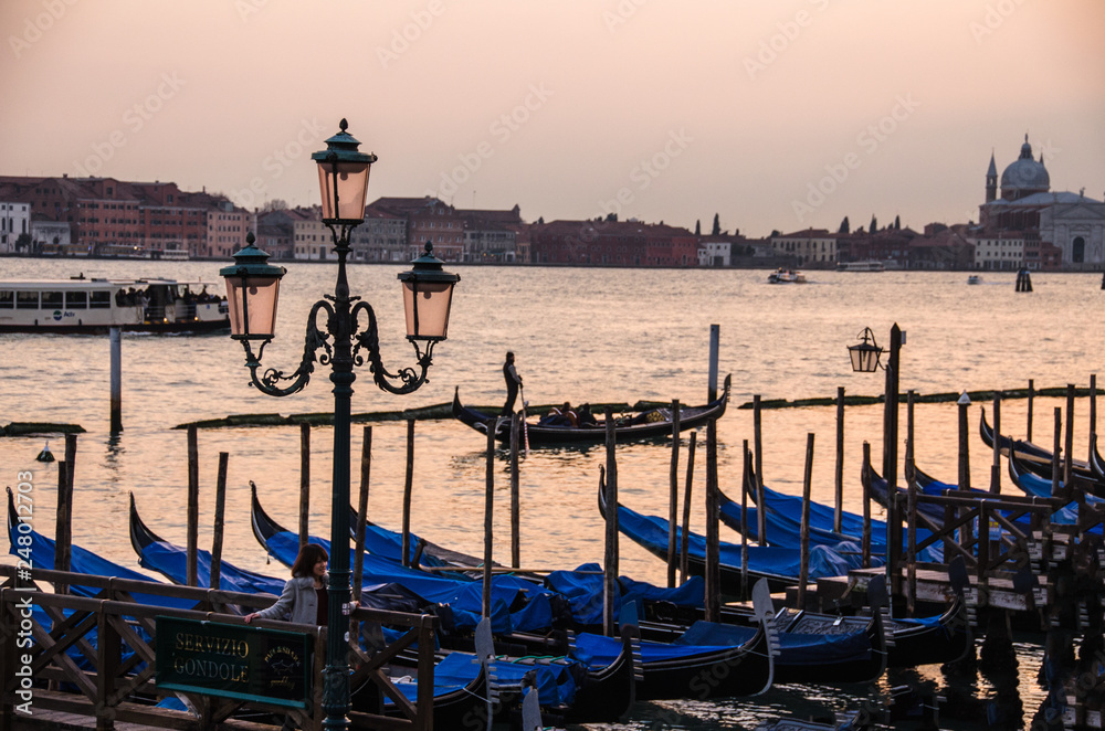 Gondolas moored by Saint Mark square with San Giorgio di Maggiore church in Venice, Italy,16:9 Ratio