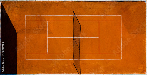 Aerial view of an empty tennis court at sunset